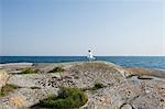Sweden, Stockholms Archipelago, Sodermanland, Haninge, Norsten, Girl (12-13) on rock looking at sea