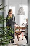 Sweden, Mother and daughter (6-7) standing in room with Christmas tree