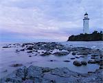 Sweden, Gotland, Faro, Lighthouse at dusk under romantic sky