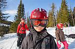 Norway, Osterdalen, Trysil, Mom and her two children (4-5, 8-9) walking down ski slope