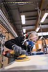 Sweden, Woman working at car workshop