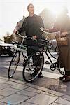 Sweden, Uppland, Stockholm, Vasastan, Two young people standing by bicycles