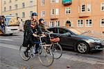 Sweden, Uppland, Stockholm, Vasatan, Sankt Eriksgatan, Man and woman cycling on city street