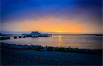 Sweden, Oland, Borgholm, Borgholms Kallbadhus, Sun setting down over pier