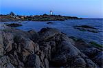 Sweden, Sodermanland, Stockholm archipelago, Oja, Landsort, Seaside rocks and distant lighthouse