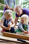 Finland, Tammerfors, Ruovesi, Father and daughters (2-3, 6-7) at summer house