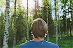 Finland, Mellersta Finland, Jyvaskyla, Saakoski, Young man looking at forest