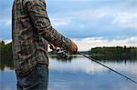Finland, Pirkanmaa, Lehtissaari, Man fishing in lake