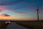 Sweden, Halland, Gullbranna, Car on empty road at dusk