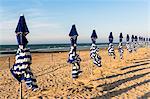 France, Normandy, beach umbrellas at the end of a summer day on the beach of Cabourg