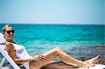 Young woman sunbathing on a deckchair