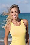 Portrait of smiling blond woman with yellow tank top