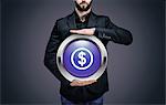 Businessman holding a circle containing the symbol "Dollar"