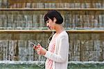 Woman listening to music by smart phone