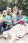 Family with young children and family dog, portrait