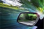 View of Road Reflected in Car's Driver's Side Mirror