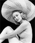 1930s PORTRAIT BLONDE WOMAN WEARING BATHING SUIT LARGE STRIPED STRAW HAT LOOKING AT CAMERA