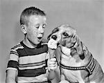 1950s FRECKLE FACE BOY SHARING ICE CREAM CONE WITH PET DOG