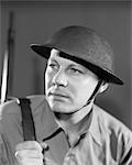 1930s 1940s SERIOUS PORTRAIT AMERICAN SOLDIER IN UNIFORM WEARING BRODIE HELMET USED BY US ARMY THROUGH 1942