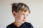 Studio portrait of boy looking away