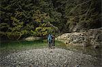 Couple by river, Lynn Canyon Park, North Vancouver, British Columbia, Canada