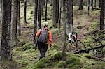 Hunter with dog in forest