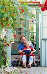 Sweden, Skane, Mossby, Portrait of daughter with father holding tablet pc