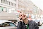 Sweden, Uppland, Stockholm, Kungsgatan, Mid-adult man talking on phone