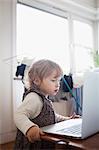 Sweden, Girl (2-3) looking at laptop