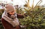 Sweden, Stockholm, Gamla Stan, Woman choosing christmas tree