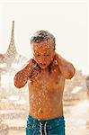 Turkey, Alanya, Girl (8-9) standing under shower on beach