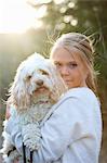 Sweden, Uppland, Lanna, Girl (12-13) holding dog