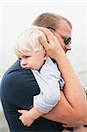 Sweden, Gotland, Ljugarn, Man embracing boy (2-3)