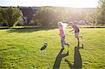 Sweden, Narke, Garphyttan, Girl (10-11) and boy (12-13) playing soccer in garden