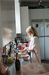 Sweden, Woman with tomatoes in kitchen