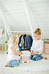 Sweden, Sisters (2-3, 6-7) playing with toy truck in bedroom