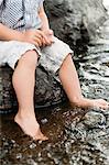 Sweden, Vastmanland, Baby boy (18-23 months) dipping feet in water