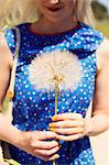 France, Woman holding dandelion