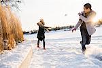 Sweden, Vasterbotten, Umea, Young couple enjoying snowball fight