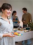 Sweden, Woman serving food, people in background