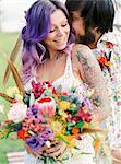 Sweden, Groom kissing bride at hippie wedding