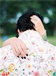 Sweden, Bride and groom in shirt with floral pattern at hippie wedding