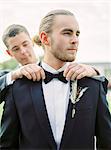 Sweden, Groom adjusting partner's bow tie at gay wedding