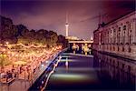 Germany, Berlin, Museum Island, Illuminated riverbank and reflections in water