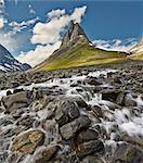 Sweden, Lappland, Nallo, Stream at foot of mountains