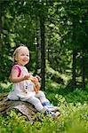 Finland, Paijat-Hame, Girl (2-3) playing with doll in forest