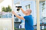 Finland, Keski-Suomi, Jyvaskyla, Man building greenhouse