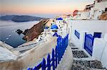 The last light of dusk over the Aegean Sea seen from the typical village of Oia, Santorini, Cyclades, Greek Islands, Greece, Europe