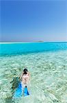 Woman snorkelling in lagoon, Rasdhoo Island, Northern Ari Atoll, Maldives, Indian Ocean, Asia
