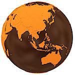 Southeast Asia on chocolate model of planet Earth. Sweet crusty continents with embossed countries and oceans made of dark chocolate. 3D illustration isolated on white background.
